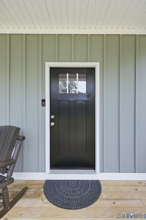 3259 Three Bridge Road Powhatan, VA 23139 - Photo 4 of 43 Board and batten exterior siding with a covered po