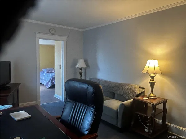 a bedroom with bed and a lamp with wooden floor