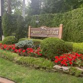a view of sign board with yard and outdoor seating