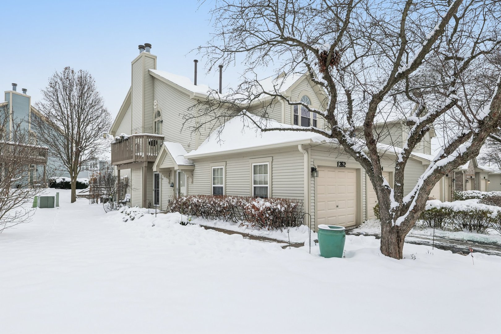 1262 Rhodes Lane Naperville, IL 60540 - Photo 2 of 23 a front view of a house with a snow covered with snow
