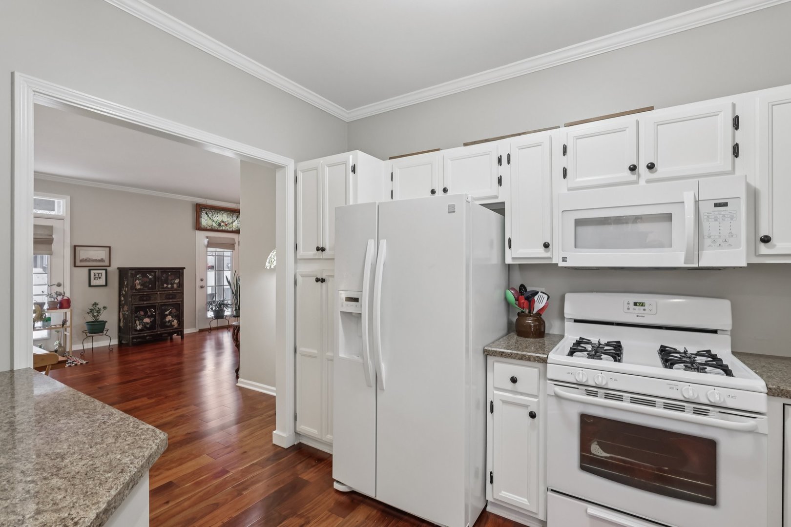 1262 Rhodes Lane Naperville, IL 60540 - Photo 4 of 23 a kitchen with cabinets and wooden floor