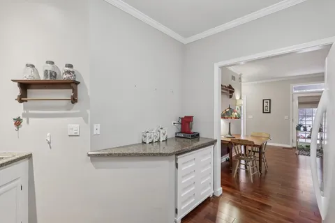 a kitchen with granite countertop a white stove and cabinets