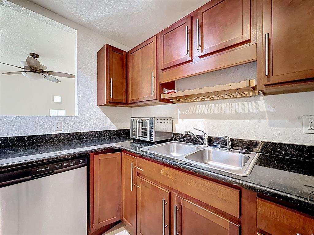1928 South Conway Road, Unit 33 Orlando, FL 32812 - Photo 11 of 34 a kitchen with stainless steel appliances granite countertop a sink stove and cabinets
