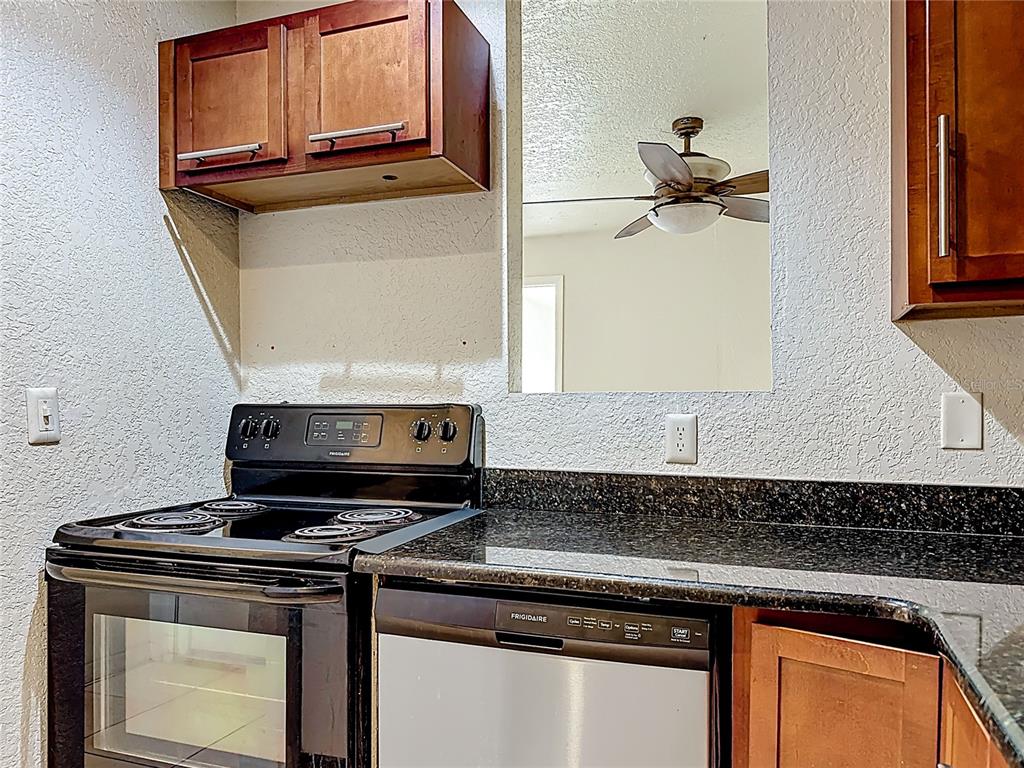 1928 South Conway Road, Unit 33 Orlando, FL 32812 - Photo 13 of 34 a stove top oven sitting inside of a kitchen