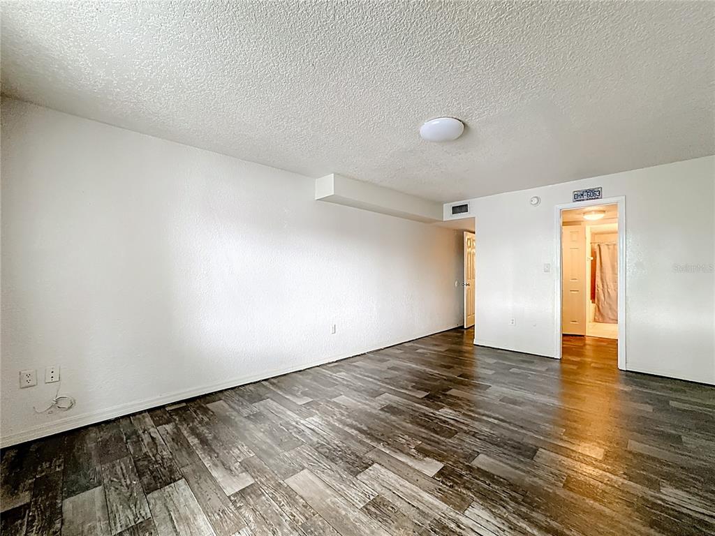 1928 South Conway Road, Unit 33 Orlando, FL 32812 - Photo 23 of 34 a view of an empty room with wooden floor and a window
