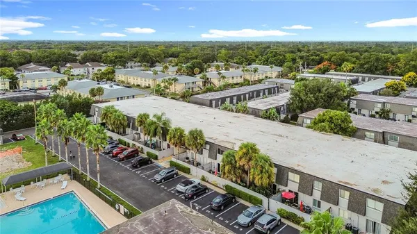 an aerial view of residential houses with outdoor space and swimming pool