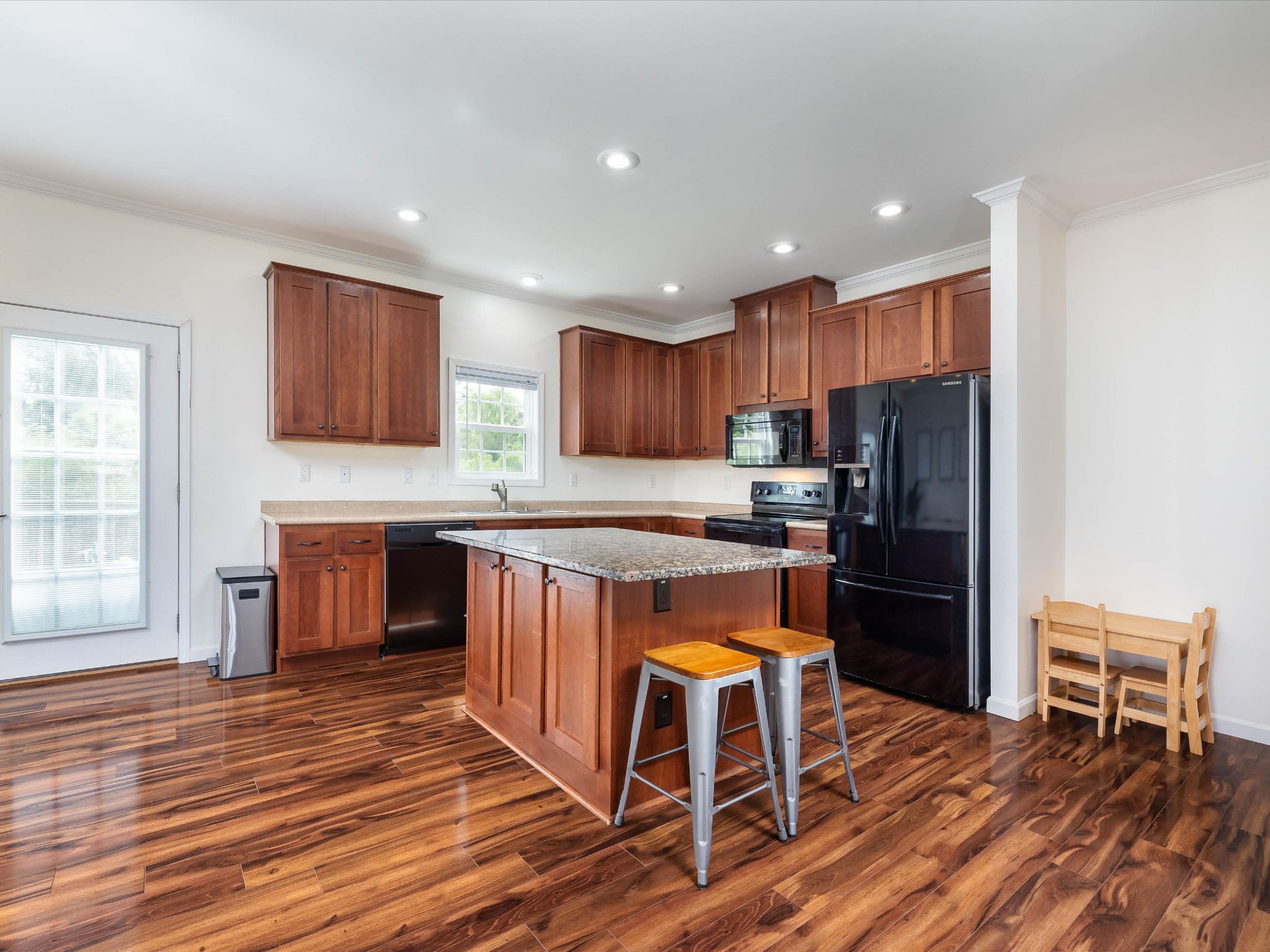 1150 Wrights Mill Road Spring Hill, TN 37174 - Photo 7 of 34 a kitchen with stainless steel appliances granite countertop a refrigerator a stove top oven a sink dishwasher and wooden cabinets with wooden floor