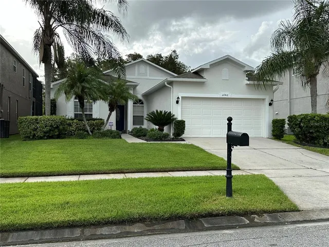 a front view of house with yard and green space
