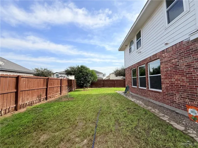a view of an house with backyard space and balcony