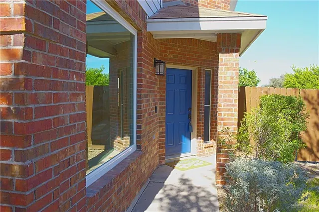 a view of a brick house with a large windows
