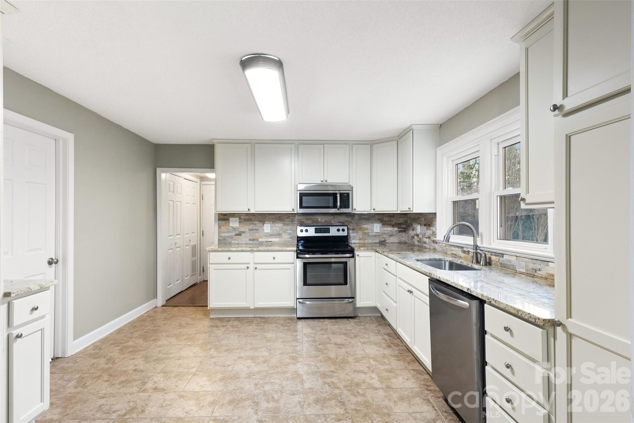 1751 Robert Martin Road Catawba, NC 28609 - Photo 22 of 29 a kitchen with stainless steel appliances granite countertop a stove sink and cabinets