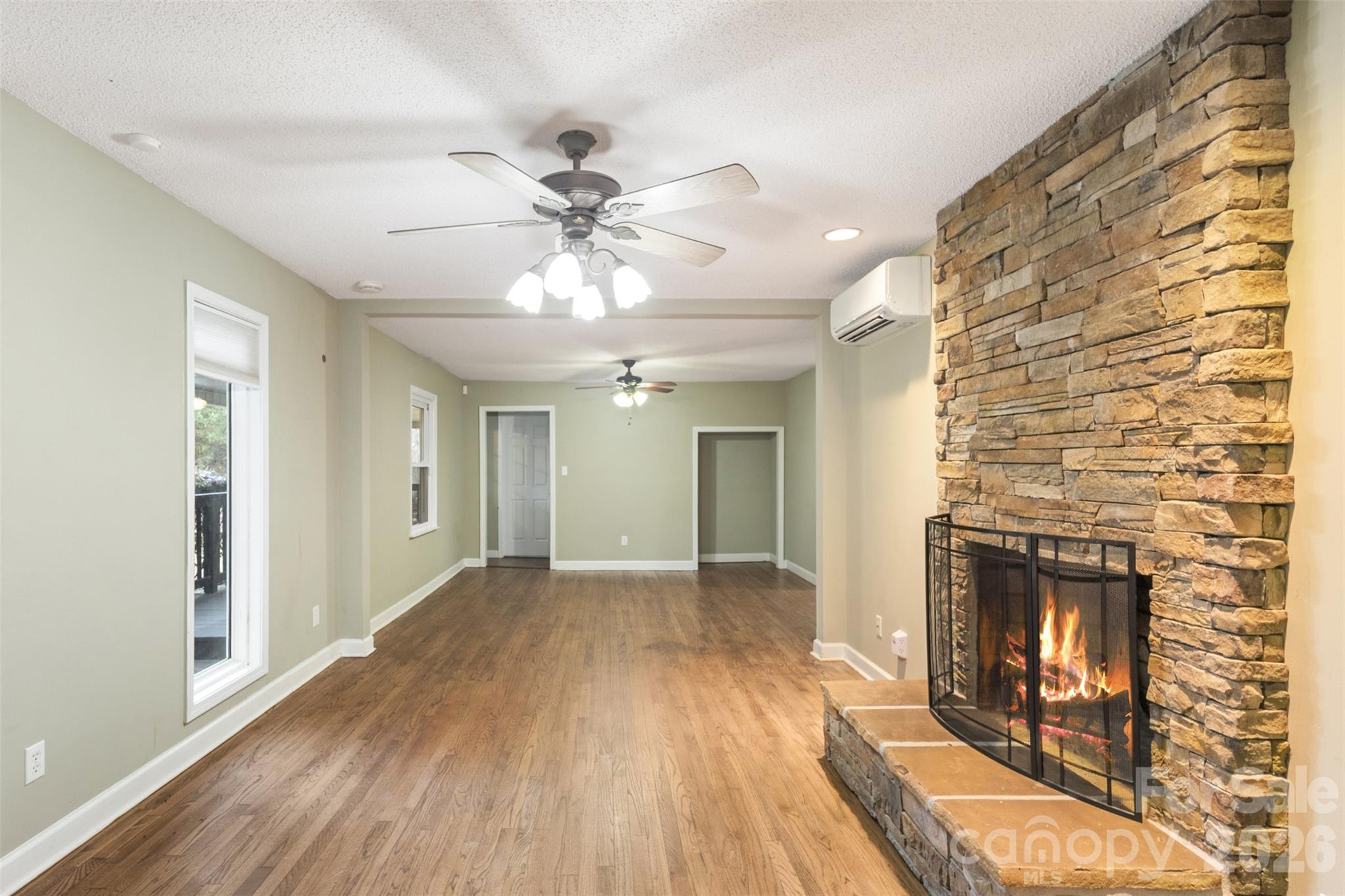 1751 Robert Martin Road Catawba, NC 28609 - Photo 24 of 29 a view of a livingroom with a fireplace a ceiling fan and wooden floor