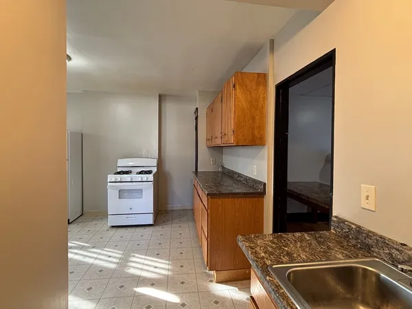 a kitchen with stainless steel appliances granite countertop a sink and a stove