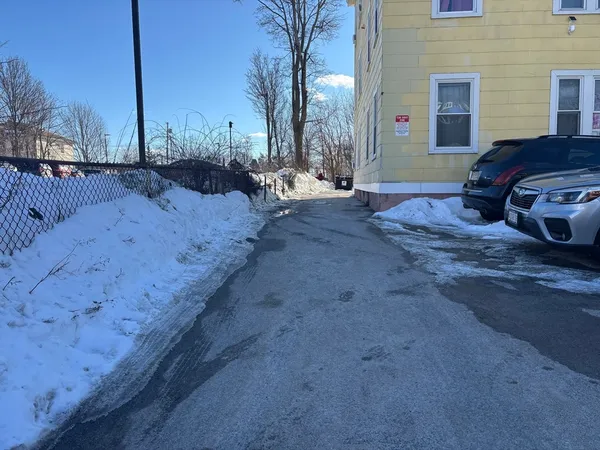 a row of car parked on the side of street