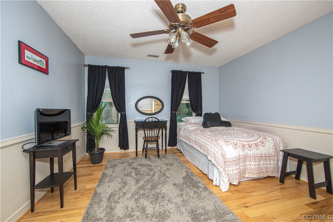 14908 Walnut Bend Road Midlothian, VA 23112 - Photo 17 of 43 a bedroom with a bed and a flat screen tv