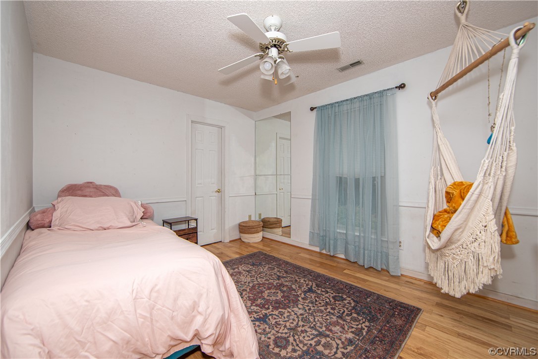 14908 Walnut Bend Road Midlothian, VA 23112 - Photo 23 of 43 a bedroom with a bed and a chandelier
