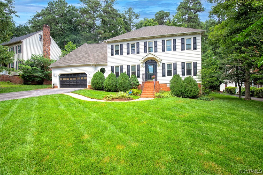 14908 Walnut Bend Road Midlothian, VA 23112 - Photo 42 of 43 a front view of a house with a yard and potted plants