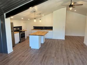 15430 Stroup Circle, Unit 2 Austin, TX 78734 - Photo 5 of 10 a kitchen with stainless steel appliances a stove top oven a sink and a refrigerator