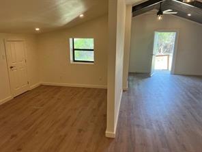 15430 Stroup Circle, Unit 2 Austin, TX 78734 - Photo 7 of 10 an empty room with wooden floor and windows