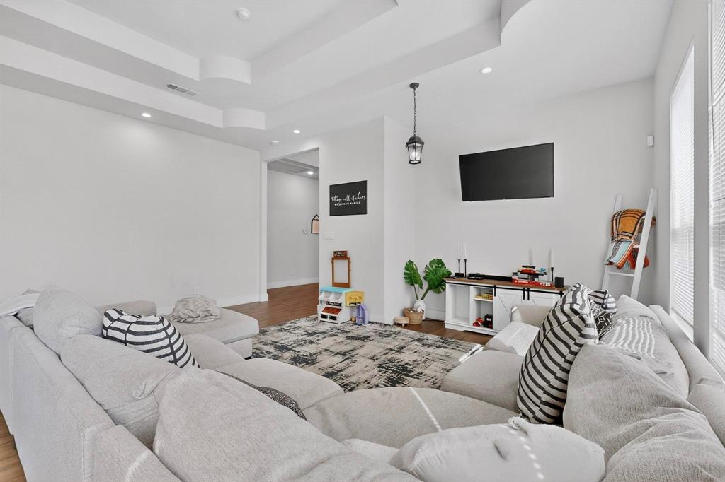 2015 Volga Avenue Dallas, TX 75216 - Photo 10 of 38 Living room with wood finished floors, a tray ceiling, and recessed lighting