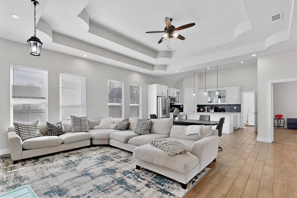 2015 Volga Avenue Dallas, TX 75216 - Photo 14 of 38 Living area with recessed lighting, a ceiling fan, wood finish floors, and a high tray ceiling