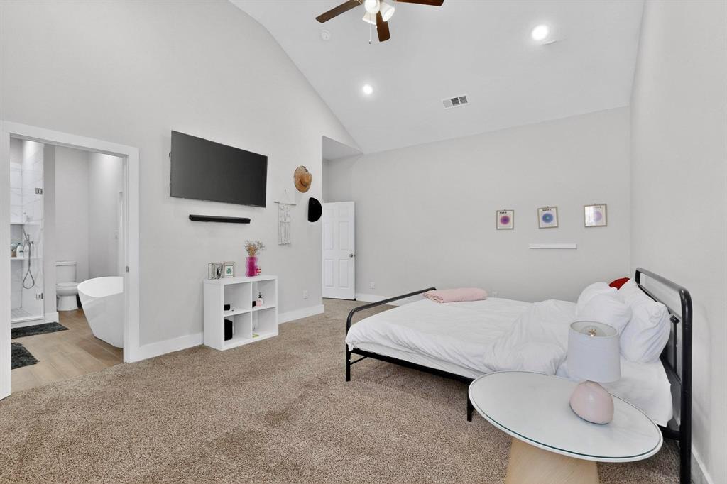 2015 Volga Avenue Dallas, TX 75216 - Photo 16 of 38 Bedroom featuring light carpet, lofted ceiling, ceiling fan, connected bathroom, and recessed lighting