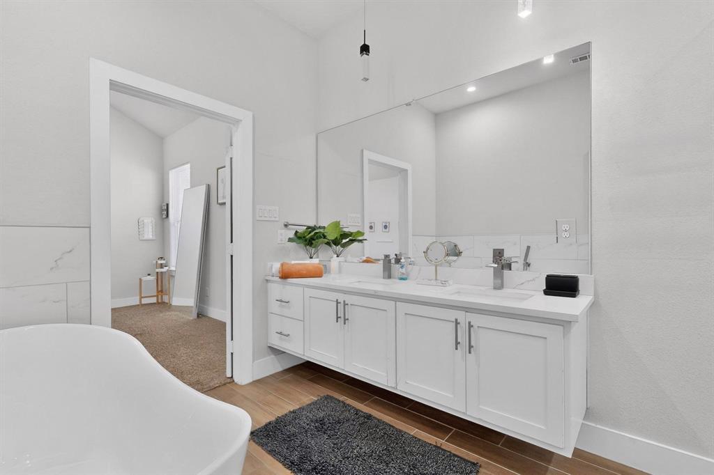 2015 Volga Avenue Dallas, TX 75216 - Photo 20 of 38 Full bathroom with vanity, a soaking tub, and wood tiled floors