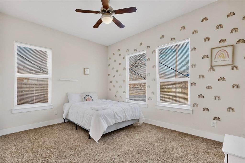 2015 Volga Avenue Dallas, TX 75216 - Photo 22 of 38 Bedroom featuring light carpet and a ceiling fan