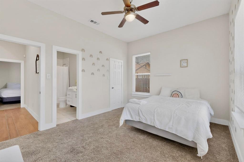 2015 Volga Avenue Dallas, TX 75216 - Photo 23 of 38 Bedroom featuring light colored carpet, a ceiling fan, and connected bathroom