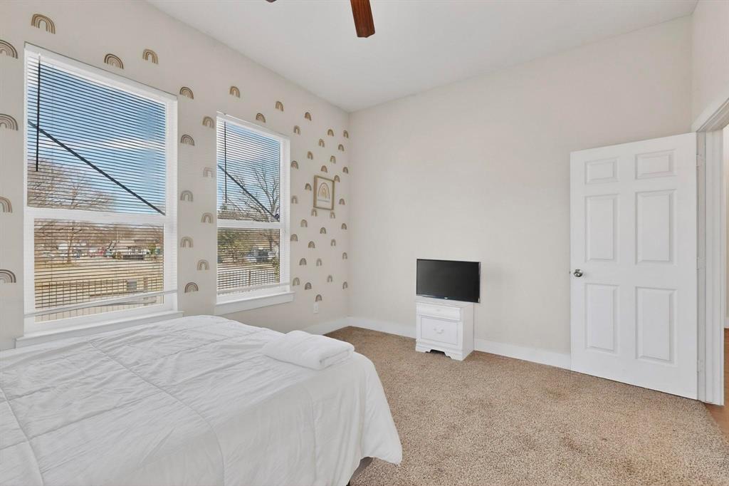 2015 Volga Avenue Dallas, TX 75216 - Photo 26 of 38 Bedroom with light colored carpet and ceiling fan