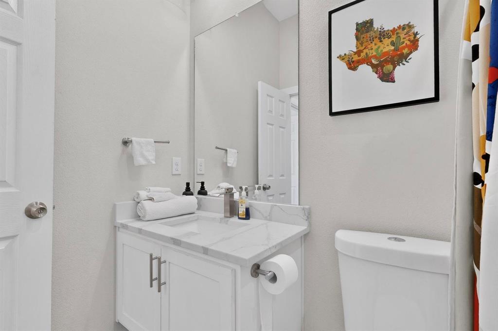 2015 Volga Avenue Dallas, TX 75216 - Photo 30 of 38 Bathroom featuring vanity and a textured wall