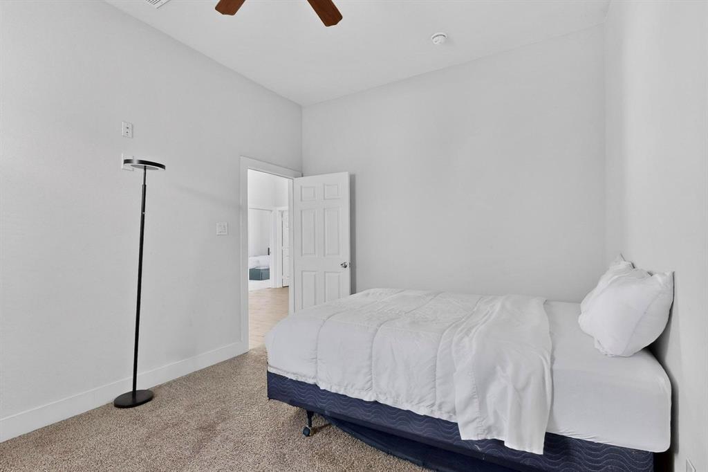 2015 Volga Avenue Dallas, TX 75216 - Photo 32 of 38 Bedroom featuring carpet flooring and a ceiling fan