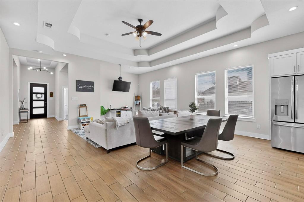 2015 Volga Avenue Dallas, TX 75216 - Photo 4 of 38 Dining space featuring recessed lighting, a ceiling fan, wood finish floors, and a raised ceiling