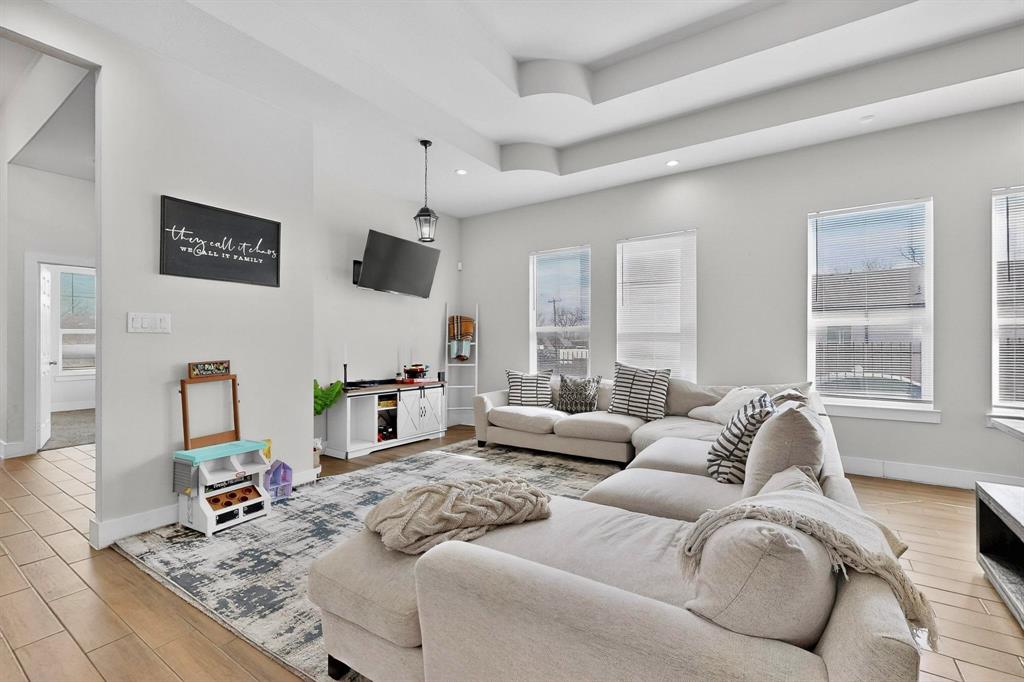 2015 Volga Avenue Dallas, TX 75216 - Photo 5 of 38 Living room featuring light wood finished floors, a tray ceiling, and recessed lighting