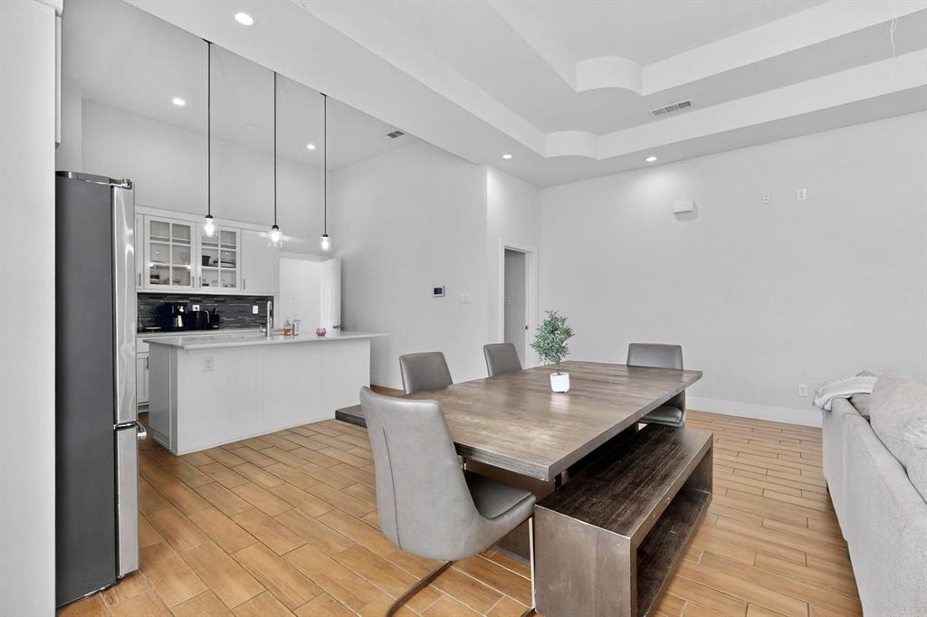 2015 Volga Avenue Dallas, TX 75216 - Photo 6 of 38 Dining room featuring wood tiled floors, a tray ceiling, and recessed lighting