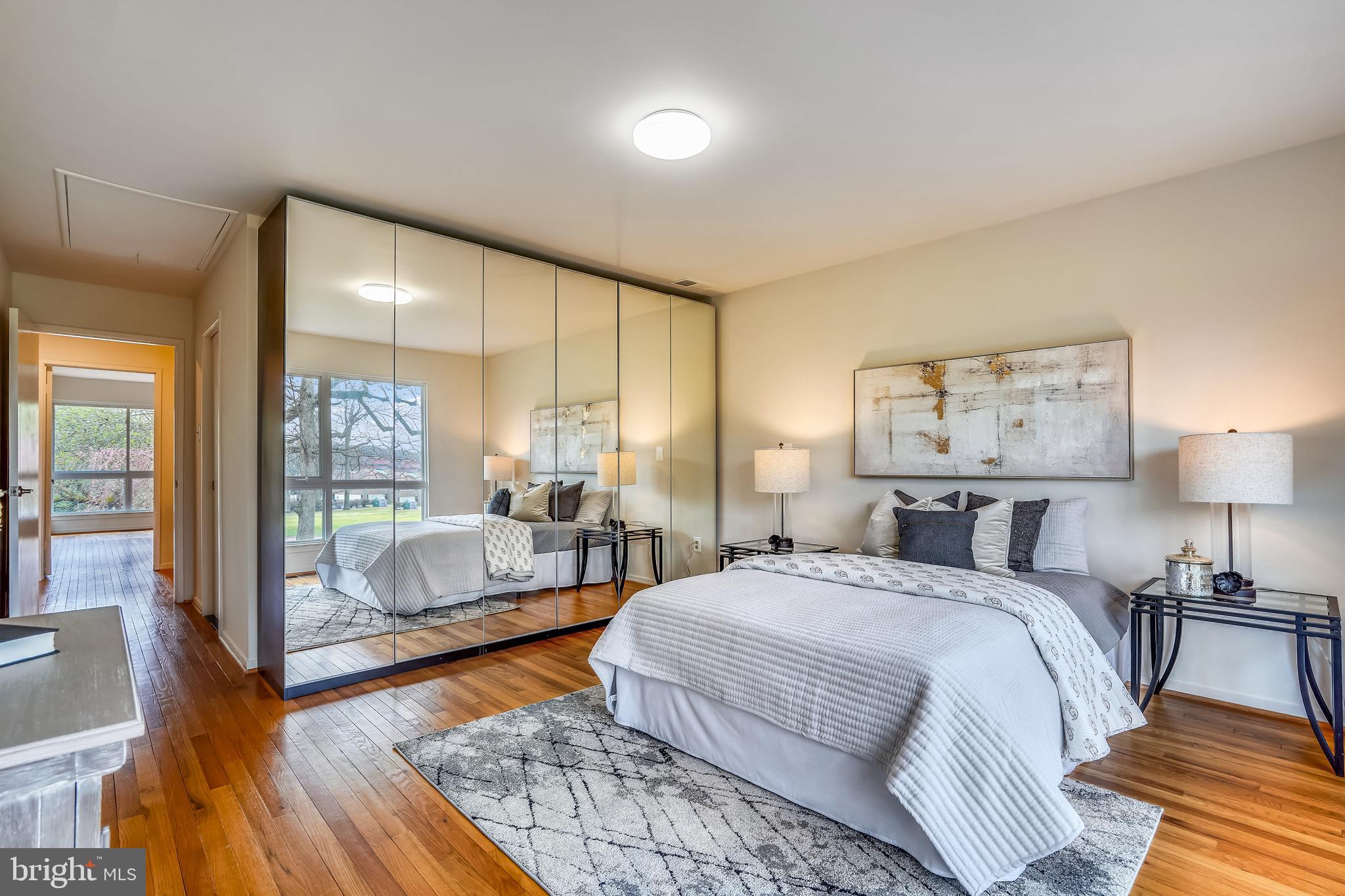 11797 Indian Ridge Road Reston, VA 20191 - Photo 17 of 33 a spacious bedroom with a bed a couch and a large window with outer view