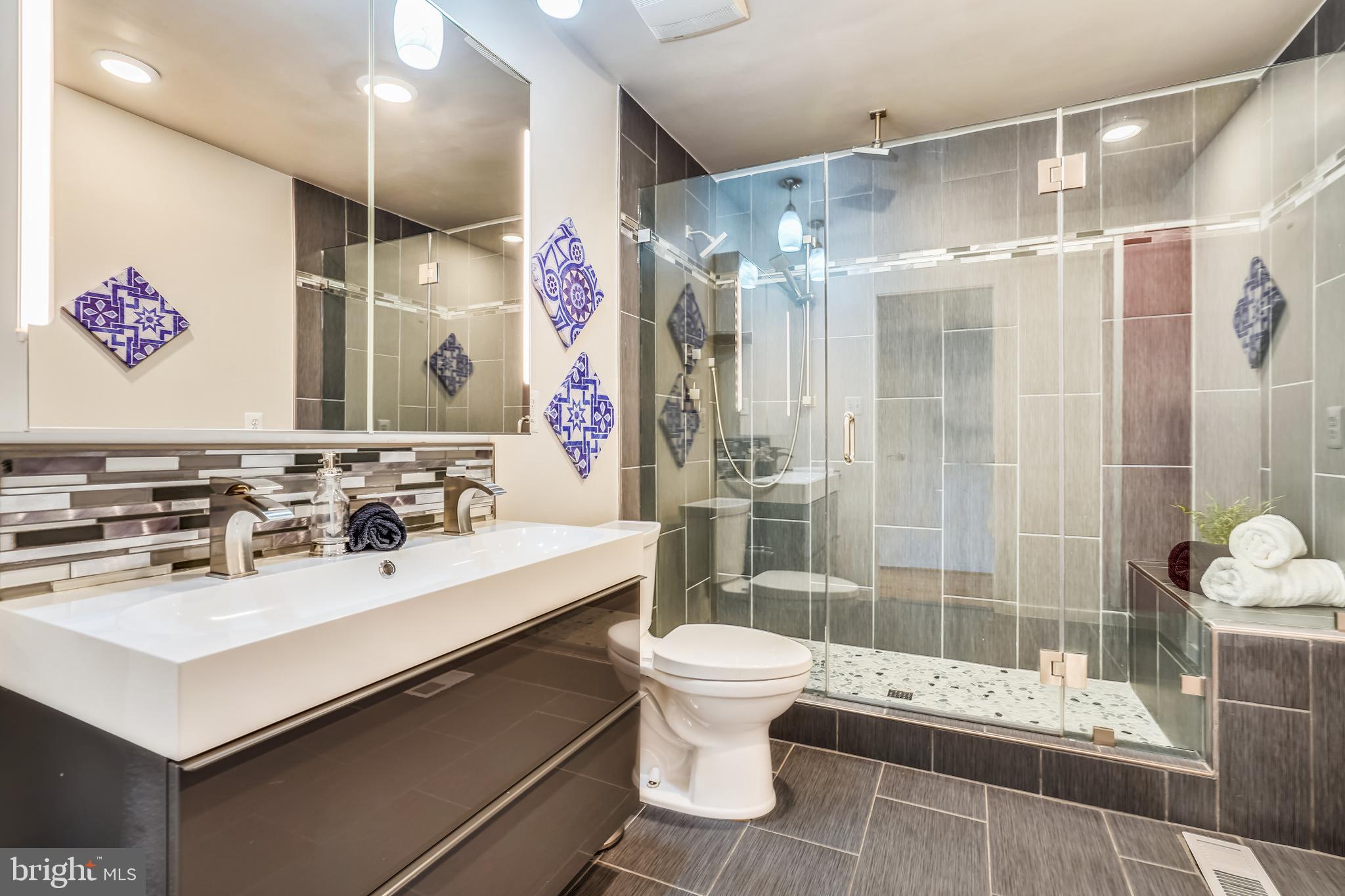 11797 Indian Ridge Road Reston, VA 20191 - Photo 18 of 33 a bathroom with a sink vanity granite toilet and shower