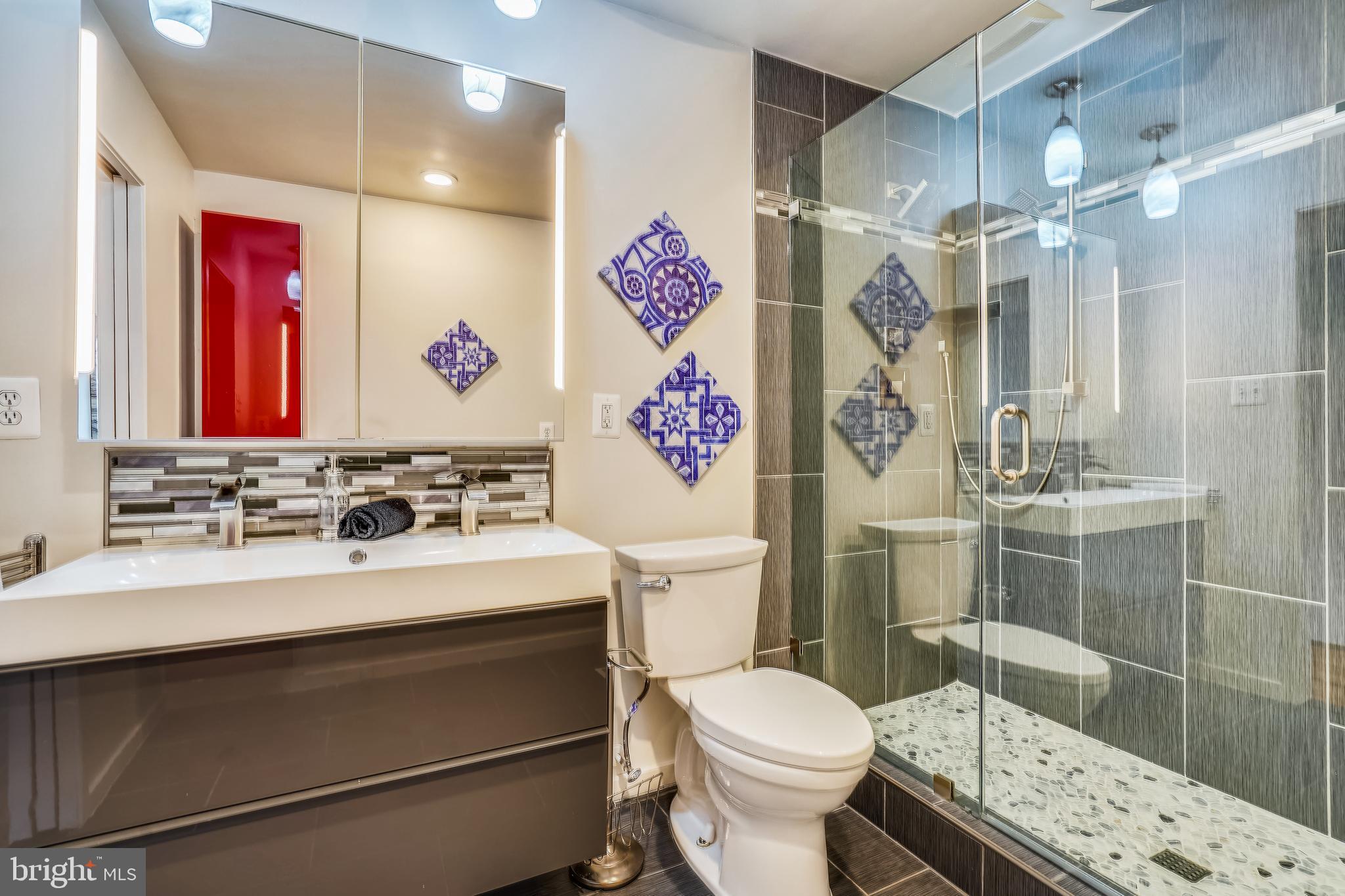 11797 Indian Ridge Road Reston, VA 20191 - Photo 19 of 33 a bathroom with a sink toilet vanity and shower