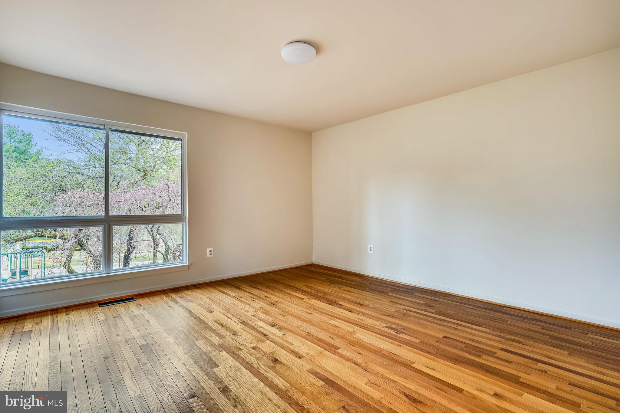 11797 Indian Ridge Road Reston, VA 20191 - Photo 20 of 33 a view of an empty room with wooden floor and a window