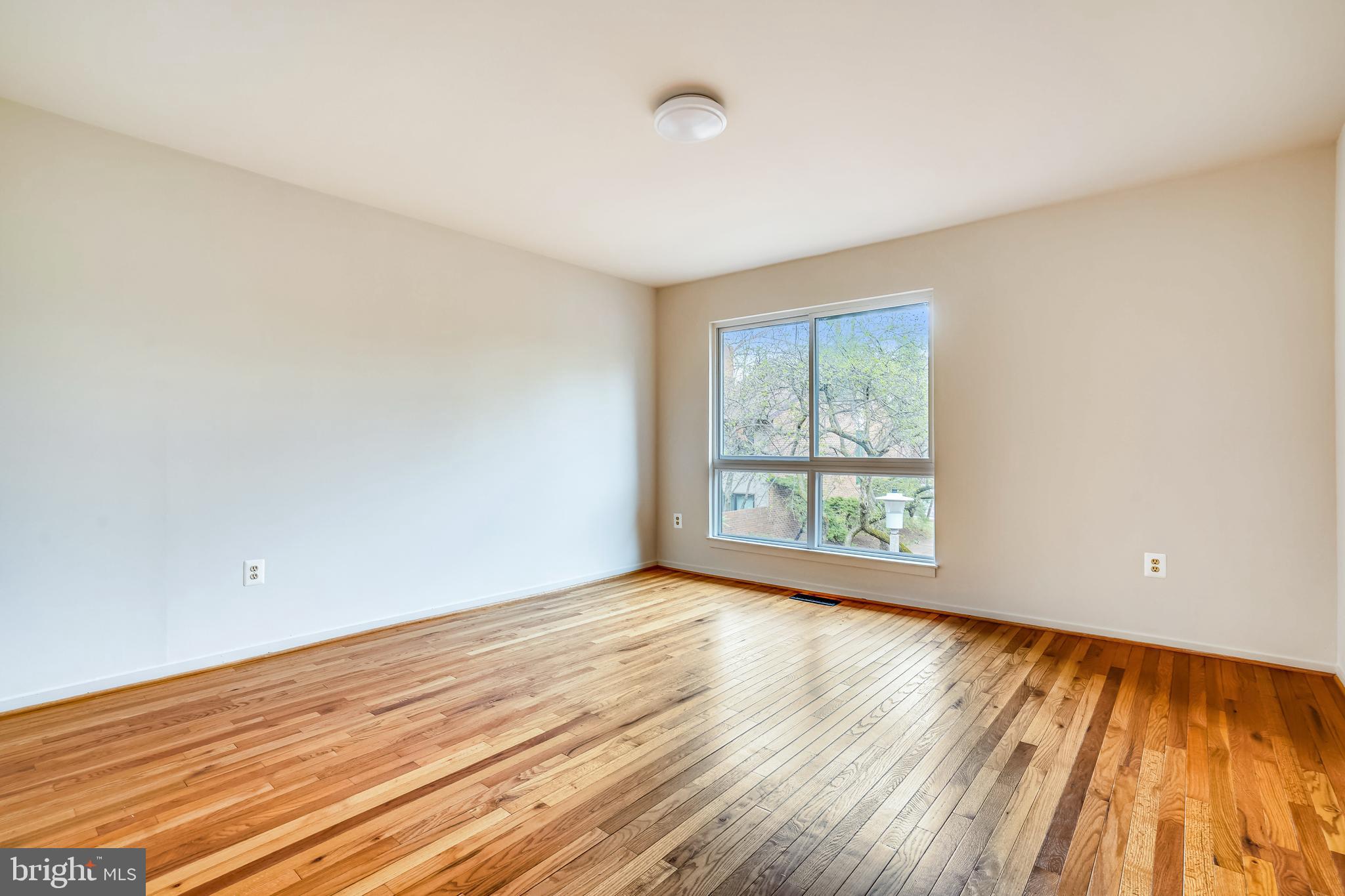 11797 Indian Ridge Road Reston, VA 20191 - Photo 22 of 33 a view of an empty room with wooden floor and a window