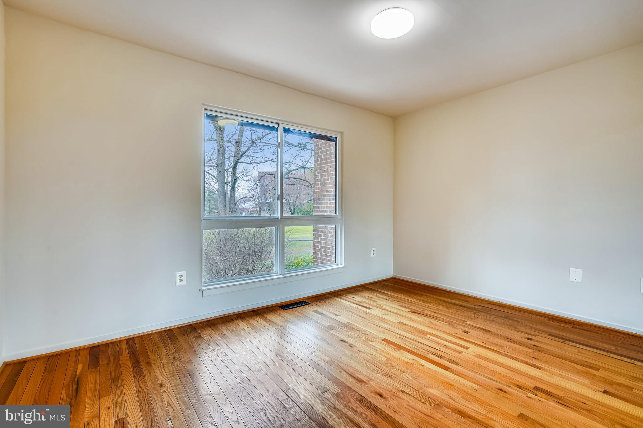 11797 Indian Ridge Road Reston, VA 20191 - Photo 25 of 33 an empty room with wooden floor and windows
