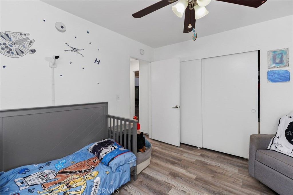 5082 Los Olivos Way Riverside, CA 92505 - Photo 21 of 36 a hallway with furniture and wooden floor
