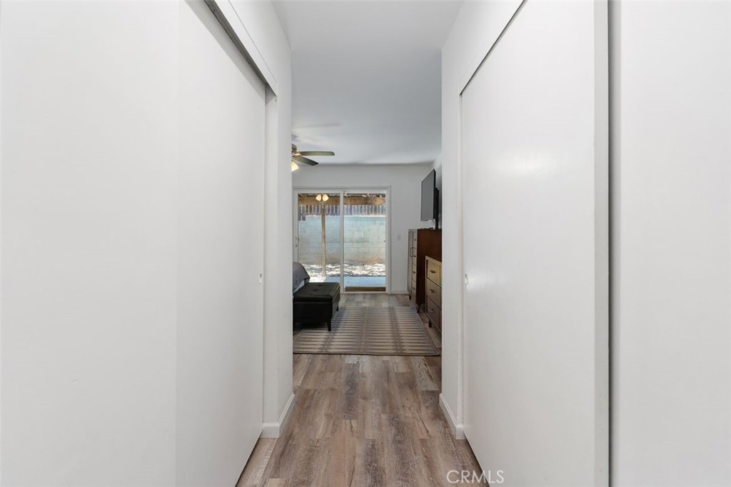 5082 Los Olivos Way Riverside, CA 92505 - Photo 23 of 36 a view of a hallway with wooden floor and a bathroom