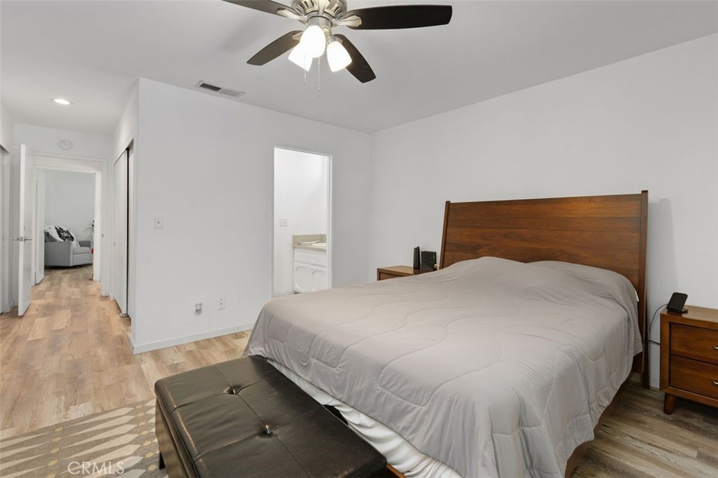 5082 Los Olivos Way Riverside, CA 92505 - Photo 26 of 36 a bedroom with a bed and a chandelier