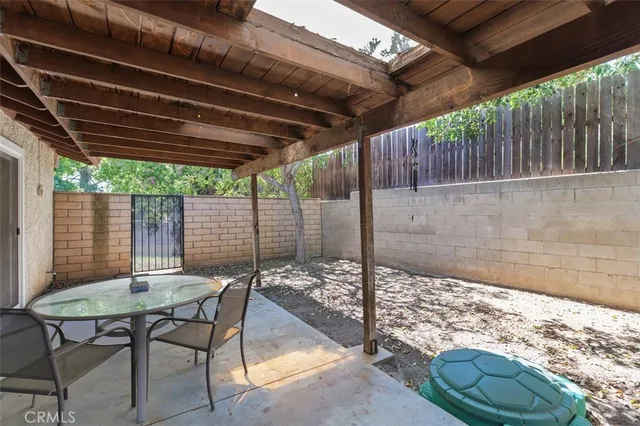 a view of a patio with table and chairs with wooden floor