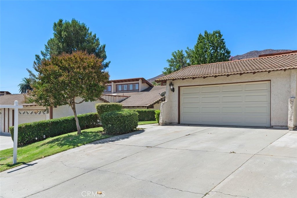 5082 Los Olivos Way Riverside, CA 92505 - Photo 4 of 36 a front view of a house with a yard and garage