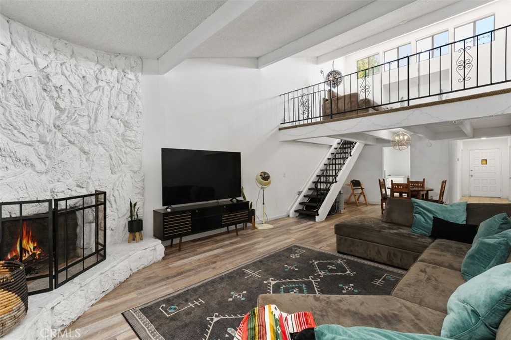5082 Los Olivos Way Riverside, CA 92505 - Photo 5 of 36 a living room with furniture a flat screen tv and a fireplace
