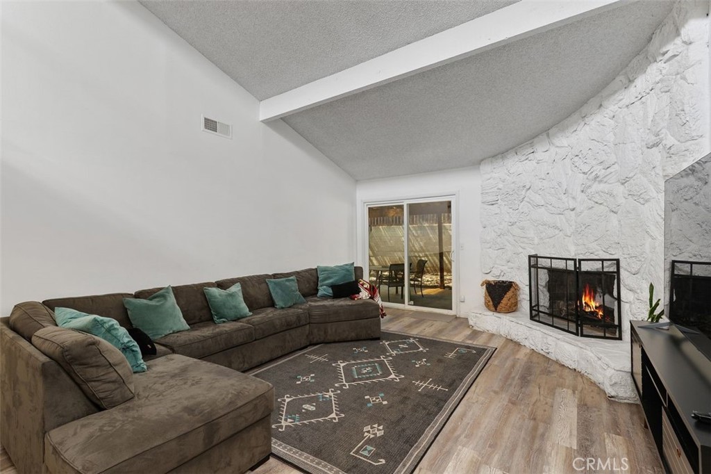 5082 Los Olivos Way Riverside, CA 92505 - Photo 8 of 36 a living room with furniture and a fireplace