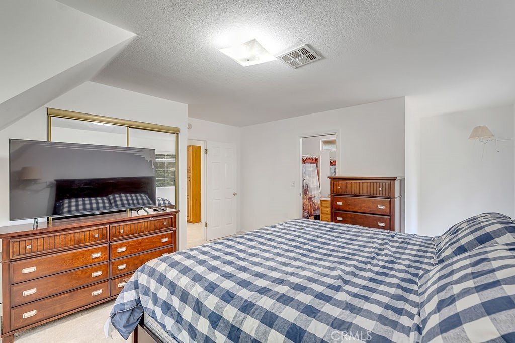 318 Old Toll Road Lake Arrowhead, CA 92352 - Photo 12 of 44 a bedroom with a bed and a fireplace