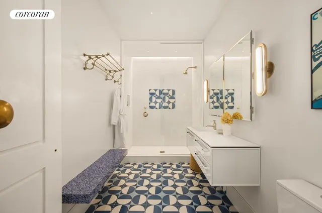 a bathroom with a sink a toilet and shower